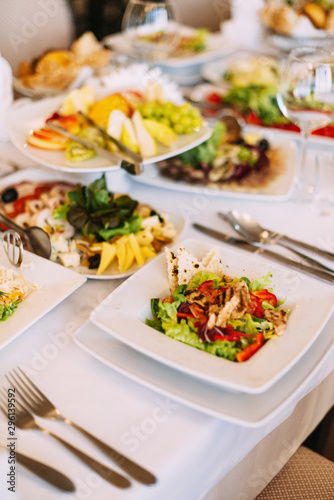 The decor of the wedding dinner. Wedding table setting. Dishes on the table in a restaurant.