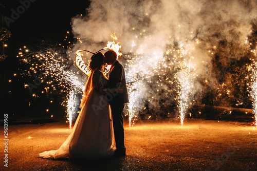 Wedding fireworks. Wedding couple silhouettes. Fire show.