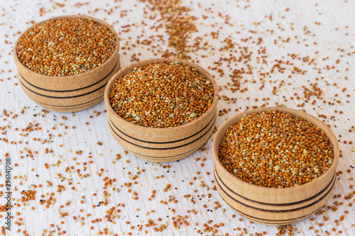 Grains of red millet in a wooden box