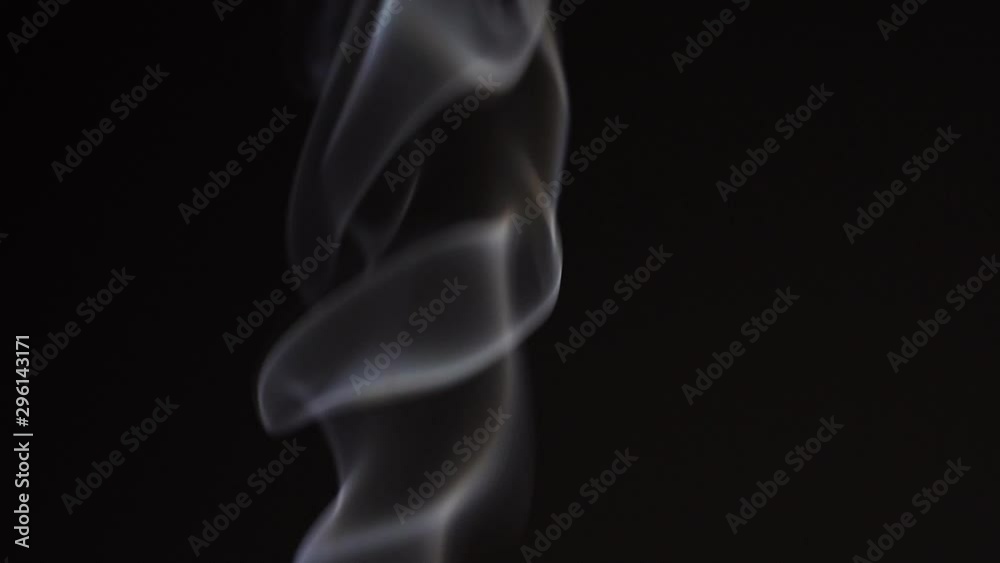 White smoke on black background in slow motion. White steam spins and rises White smoke on black background in slow motion. White steam spins and rises