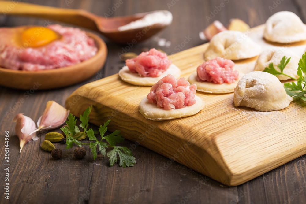 process of making home-made dumplings. Raw homemade dumplings on a wooden board. russian dumplings process of making home-made dumplings. Raw homemade dumplings on a wooden board. russian dumplings