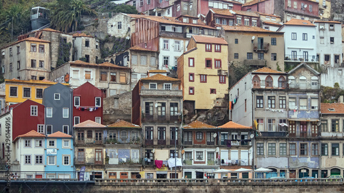 Cityscape image of Porto, Portugal, with old town Ribeira at foggy afternoon