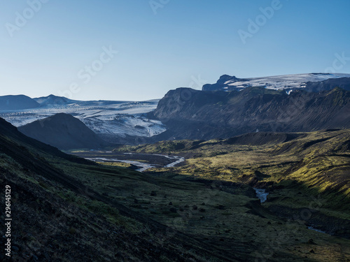 Icelandic landscape with eyjafjallajokull glacier tongue, Markarfljot river and green hills. Fjallabak Nature Reserve, Iceland. Summer blue sky