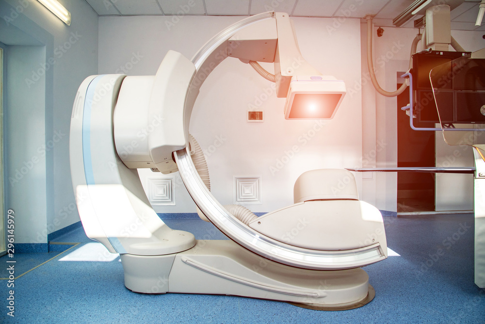 Angiographer in a modern hospital for heart surgery with a scaner and monitors