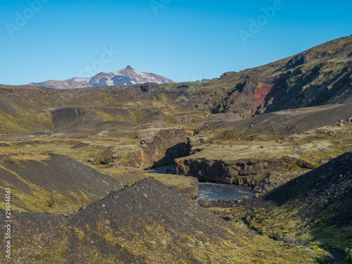 Icelandic landscape with blue Markarfljot river canyon, green hills and Tindfjallajokull glacier mountain peak. Fjallabak Nature Reserve, Iceland. Summer blue sky photo