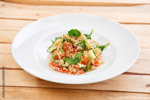 An easy, zesty summer salad with a Mediterranean flair featuring Israeli couscous and chopped summer vegetables