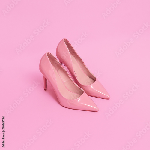 Pink patent leather shoes on a pink background. Pastel colours trends