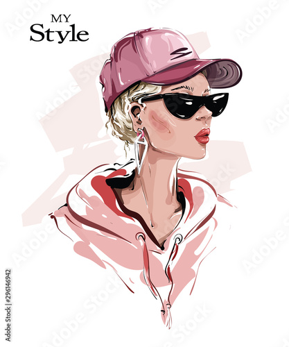 Hand drawn beautiful young woman in cap. Stylish girl in sunglasses. Fashion woman look. Sketch. Vector illustration.