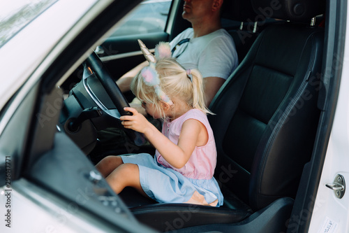 Little girl pretends to drive a car