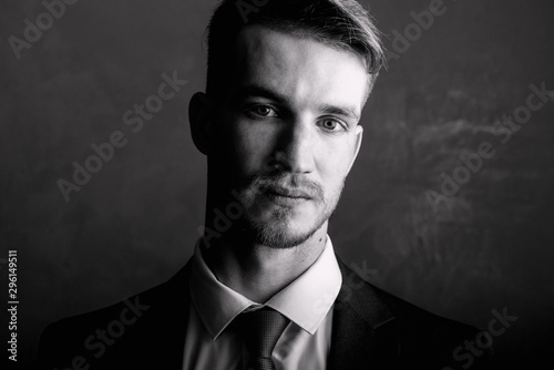 Portrait of a man black-white. Brutal man in a suit.