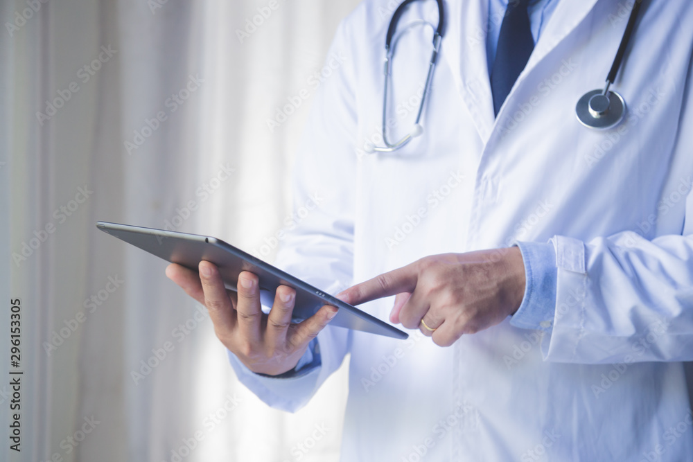 Doctor man using tablet computer for network research or virtual disease treatment, hands close-up. medic data and healthcare concept. Doctor man using tablet computer for network research or virtual disease treatment, hands close-up. medic data and healthcare concept.