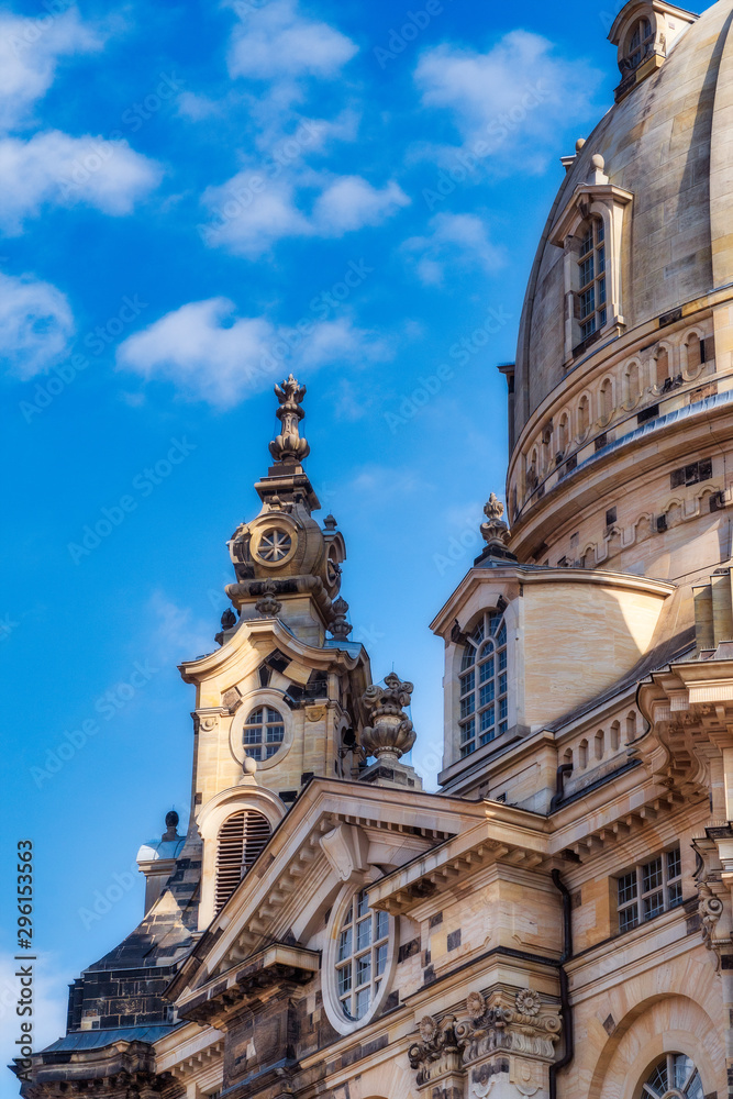 detail shot of dresdner frauenkirche with blue sky and some clouds in sunlight at day in summer