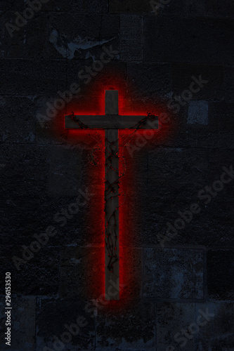 Obraz na plátně Big ominous wooden crucifix on a dark, stone wall wrapped in incandescent barbed