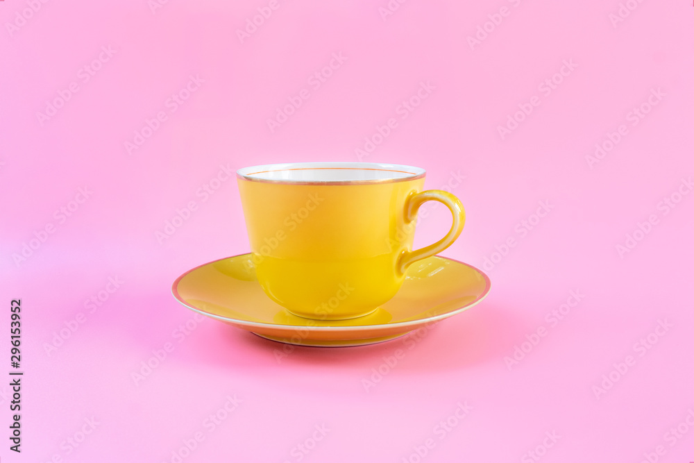 Empty yellow cup on pink pastel color background. Yellow mug empty blank for coffee or tea. concept relax Empty yellow cup on pink pastel color background. Yellow mug empty blank for coffee or tea. concept relax