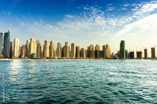 Dubai coast skyline from the sea with jumeirah beach sandy colored skyscrapers photo