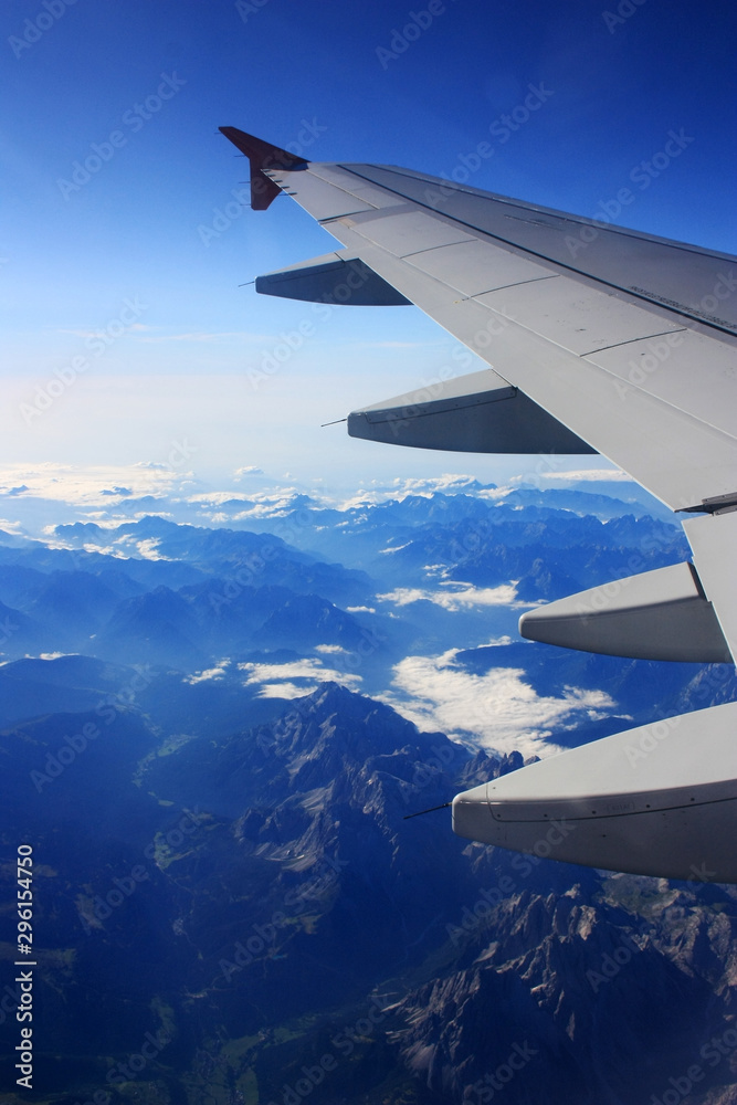 Fototapeta premium Airplane flies over the mountains