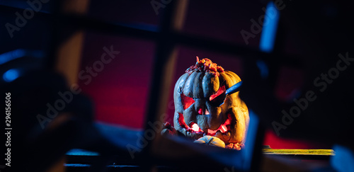 Scary Halloween pumpkins on wood in a spooky place at night. Poster concept.