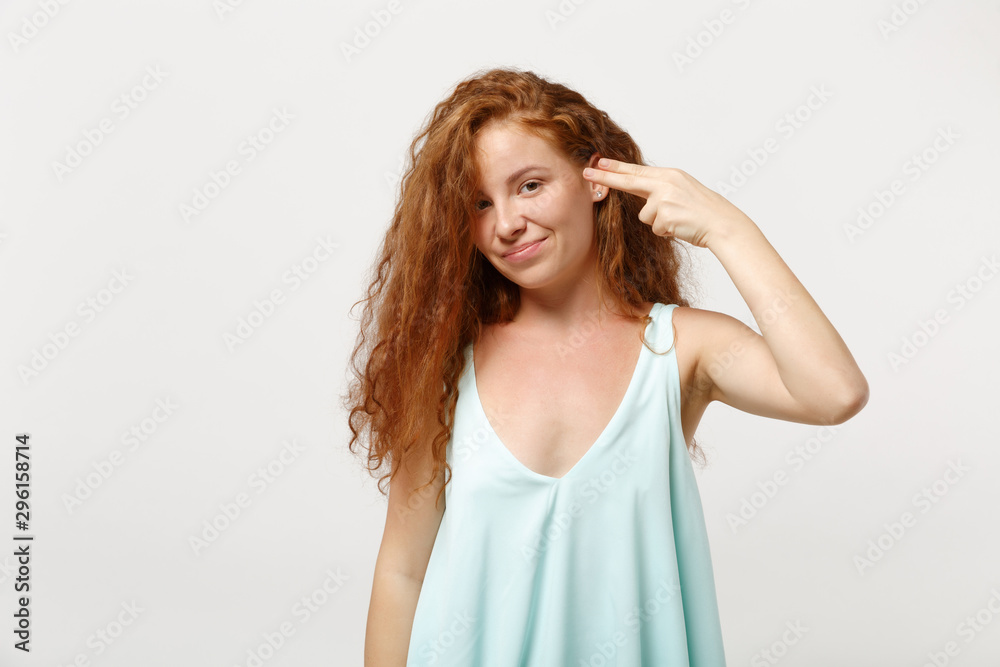 Young redhead woman girl in casual light clothes posing isolated on white background studio portrait. People lifestyle concept. Mock up copy space. Point fingers to head as if she about shoot herself. Young redhead woman girl in casual light clothes posing isolated on white background studio portrait. People lifestyle concept. Mock up copy space. Point fingers to head as if she about shoot herself.