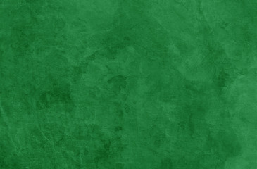 Green Christmas background texture, old vintage textured holiday paper or wallpaper with painted elegant green colors with marbled stone or rock wall