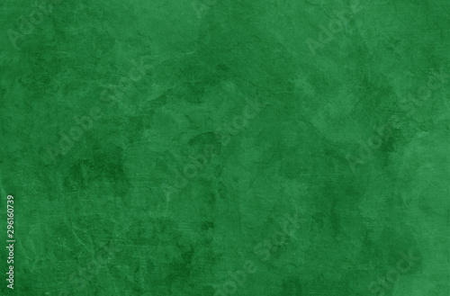 Green Christmas background texture, old vintage textured holiday paper or wallpaper with painted elegant green colors with marbled stone or rock wall