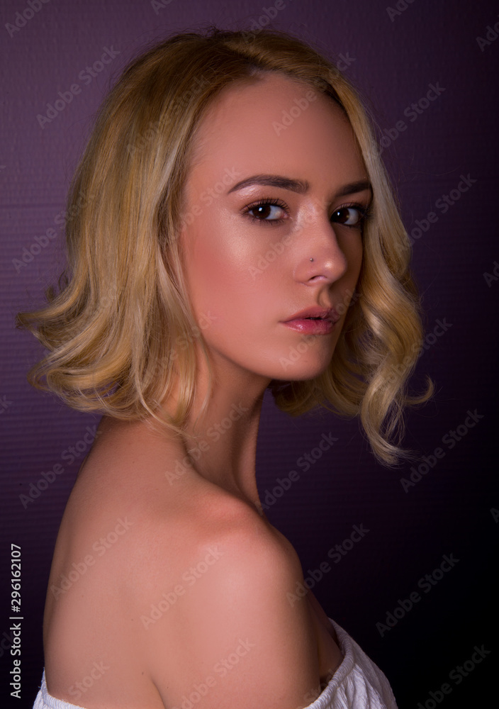 Woman modern hair cut, blonde middle length ironed curly, isolated in studio Woman modern hair cut, blonde middle length ironed curly, isolated in studio
