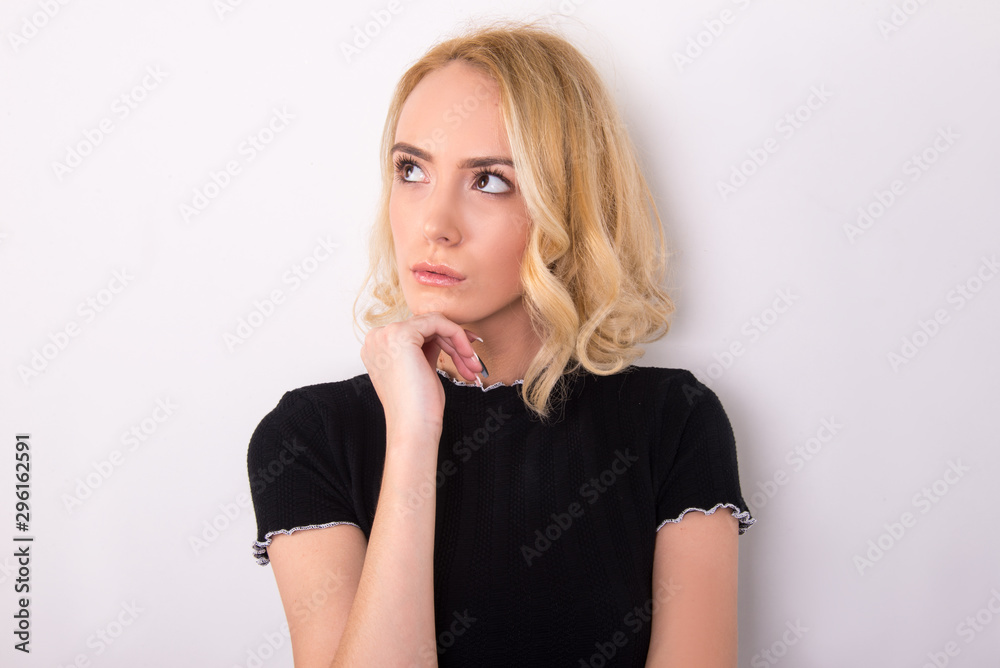 Obraz premium thinking face expression, young woman, girl model thinking isolated in studio, close up