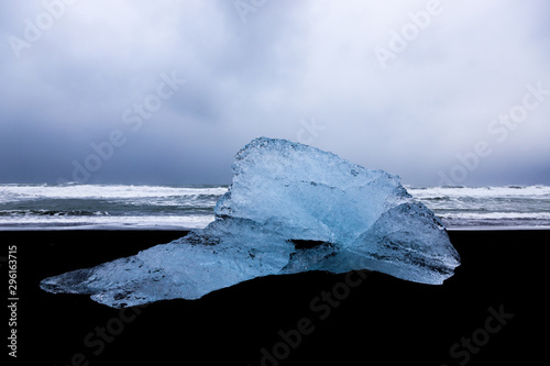 Icebergs sit on black sand Diamond Beach, Jokulsarlon, in the Arctic, Iceland, polished and glistening like jewels. photo