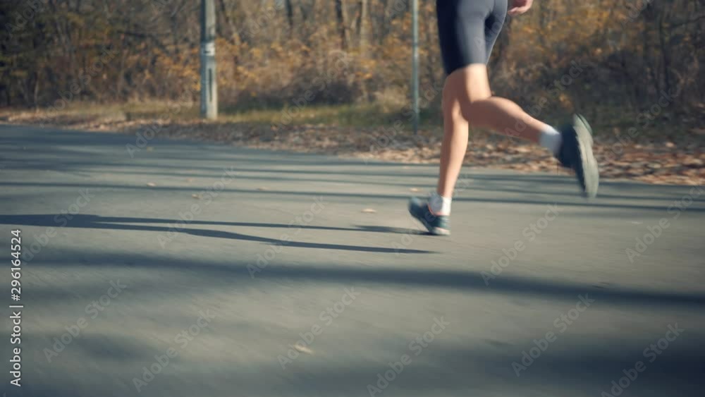 Runner Triathlete On Triathlon.Running Man In Sportswear Preparing To Triathlon And Sprinting In Park On Fall.Triathlete Ready For Marathon And Hard Training Before Running Competition.Sport Concept Runner Triathlete On Triathlon.Running Man In Sportswear Preparing To Triathlon And Sprinting In Park On Fall.Triathlete Ready For Marathon And Hard Training Before Running Competition.Sport Concept