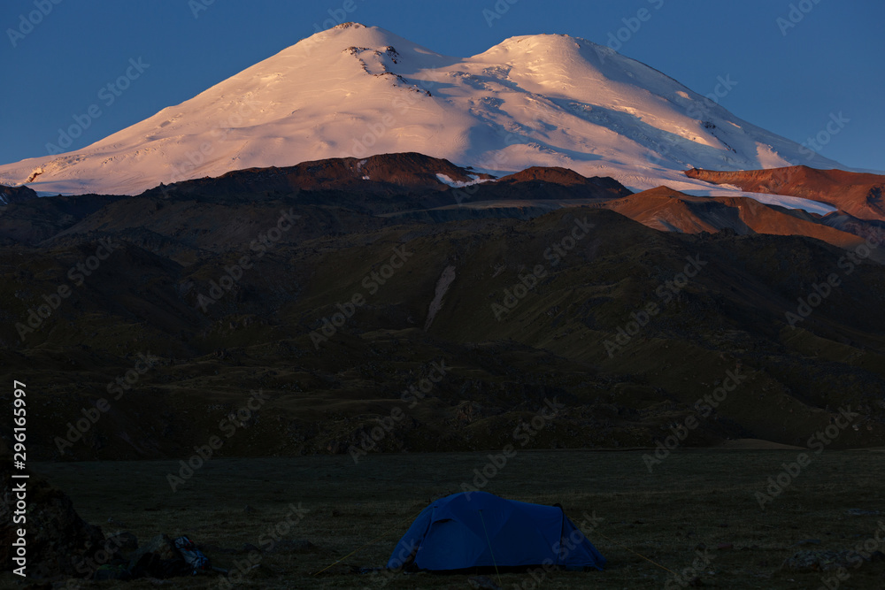 Tourist tent on the background of the snowy peaks of Mount Elbrus