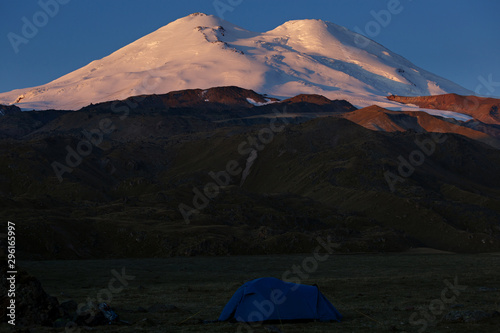 Tourist tent on the background of the snowy peaks of Mount Elbrus © olgapkurguzova