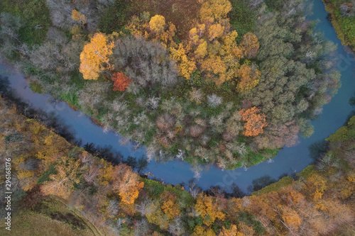 Aerial view with a drone. Winding river with autumn forest, top view © Vitalii Makarov