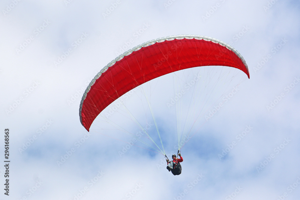 Paraglider flying wing in a blue sky Paraglider flying wing in a blue sky