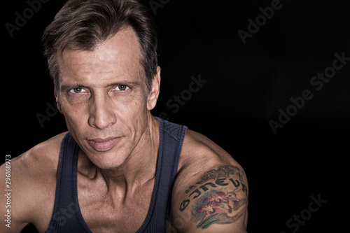40-50 years old fit man with a vest looking at the camera