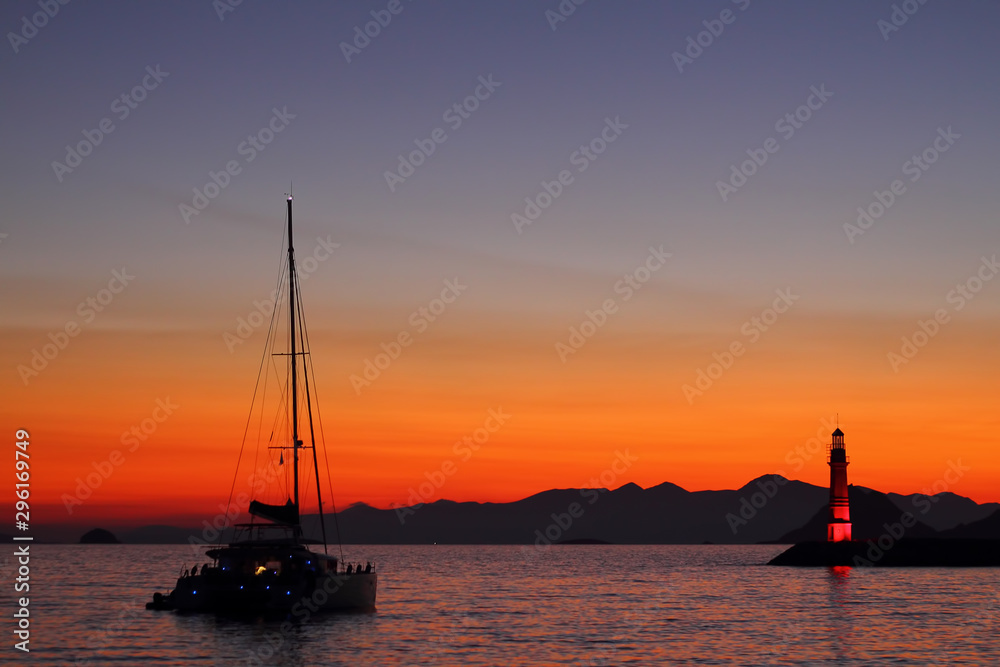 Seascape at sunset. Lighthouse on the coast. Seaside town of Turgutreis and spectacular sunsets Seascape at sunset. Lighthouse on the coast. Seaside town of Turgutreis and spectacular sunsets
