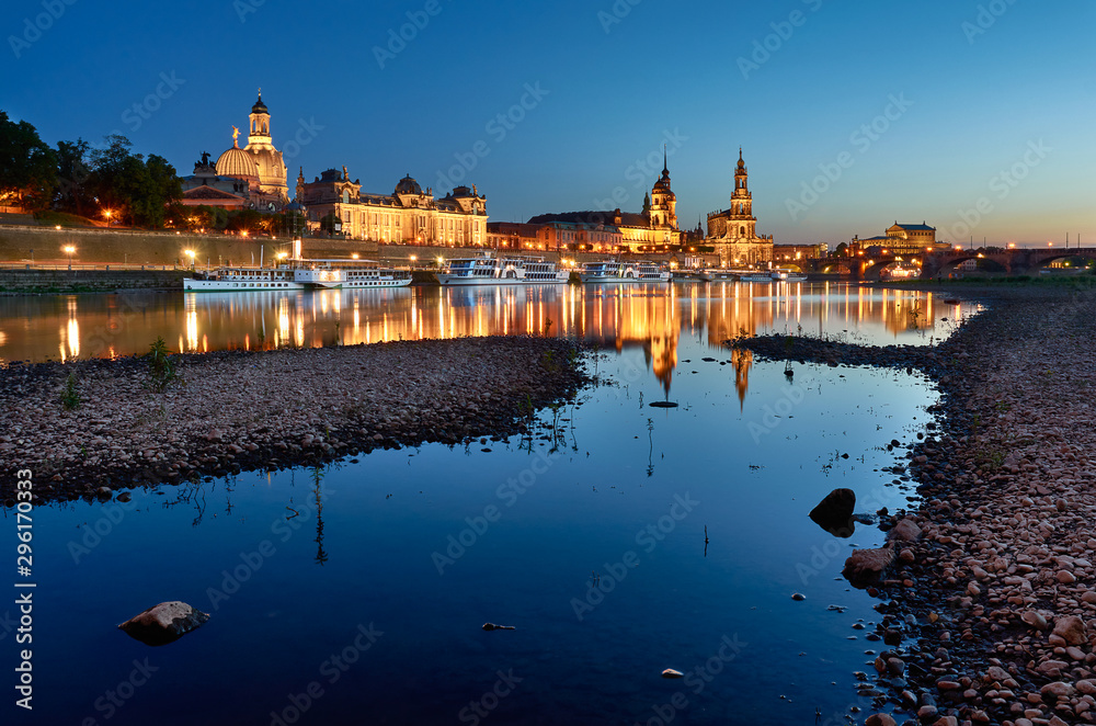 Dresden city skyline in blue hour from the river with rocks