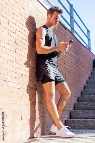 Portrait of a young man checking sport results on smartphone