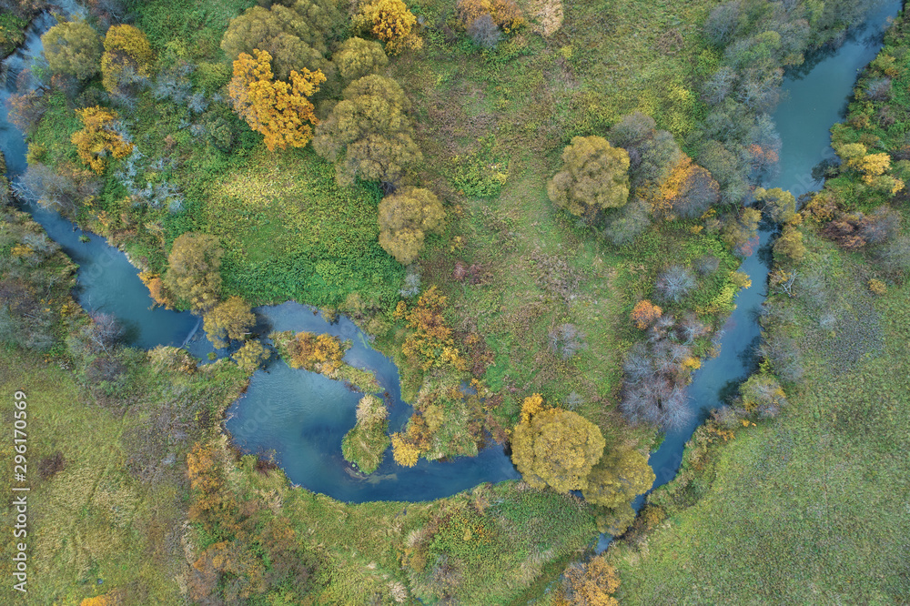 Aerial view with a drone. Winding river with autumn forest, top view