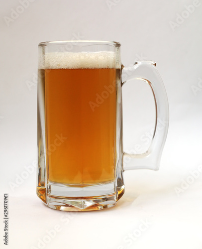Glass of light beer on a white background, close-up