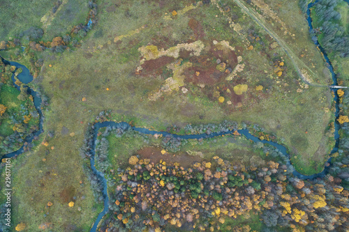Aerial view with a drone. Winding river with autumn forest, top view