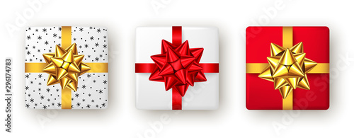 Gift box with red, golden ribbon and bow, top view.