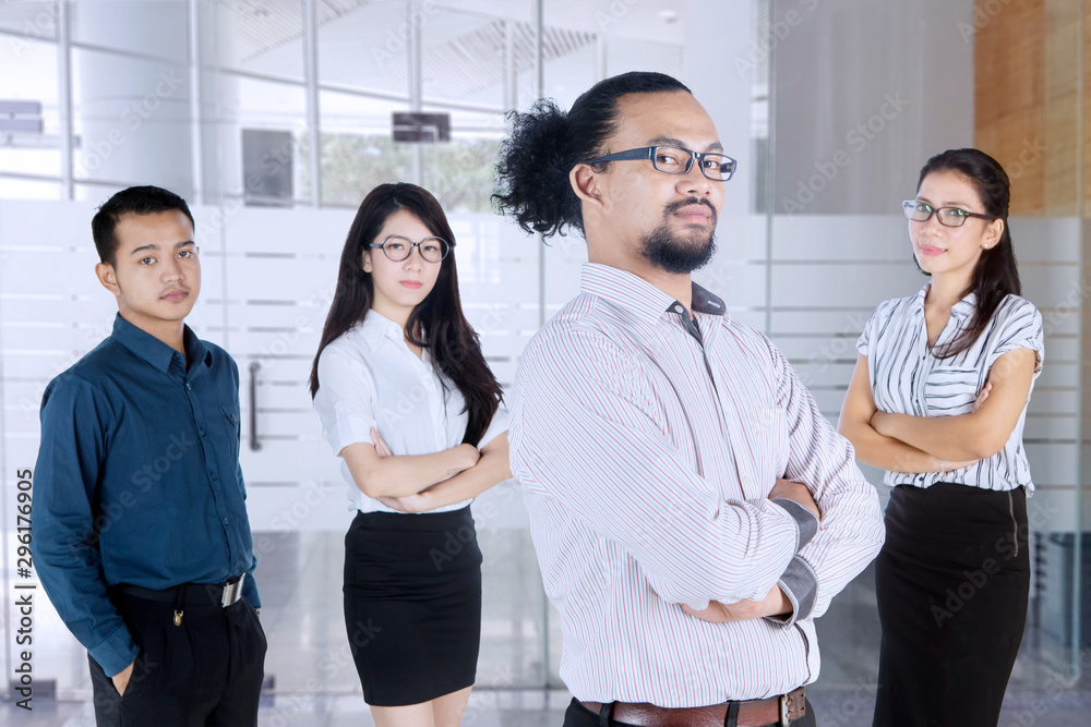 Business people stands with folded arms in office Business people stands with folded arms in office