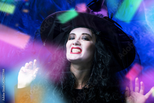 Halloween Witch ,Beautiful young woman in witches hat and costume © karepa