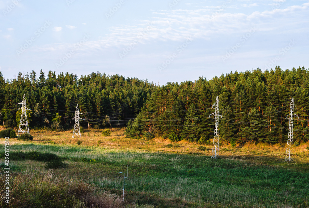Power line with metal supports on forest background Power line with metal supports on forest background