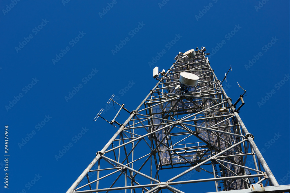 Telecommunication tower with clear blue sky background. Antenna on blue sky. Radio and satellite pole. Communication technology. Telecommunication industry. Mobile or telecom 4g and 5g network. 