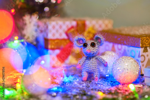 Knitted mouse is surrounded by Christmas decorations. Year of rat. symbol of 2020. © Eduard Vladimirovich