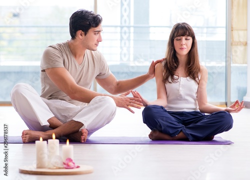 Personal coach helping during yoga session