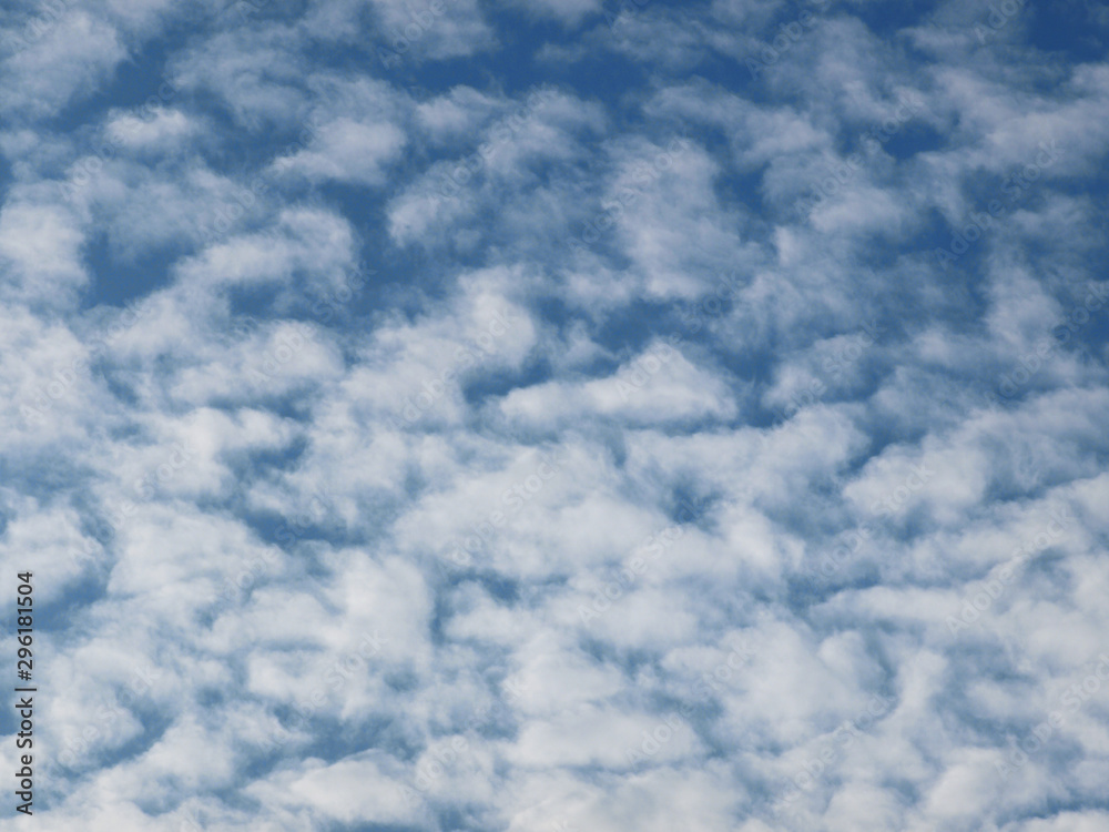 Summer background with white flying clouds on blue sky. Romantic natural heaven backdrop. Summer background with white flying clouds on blue sky. Romantic natural heaven backdrop.