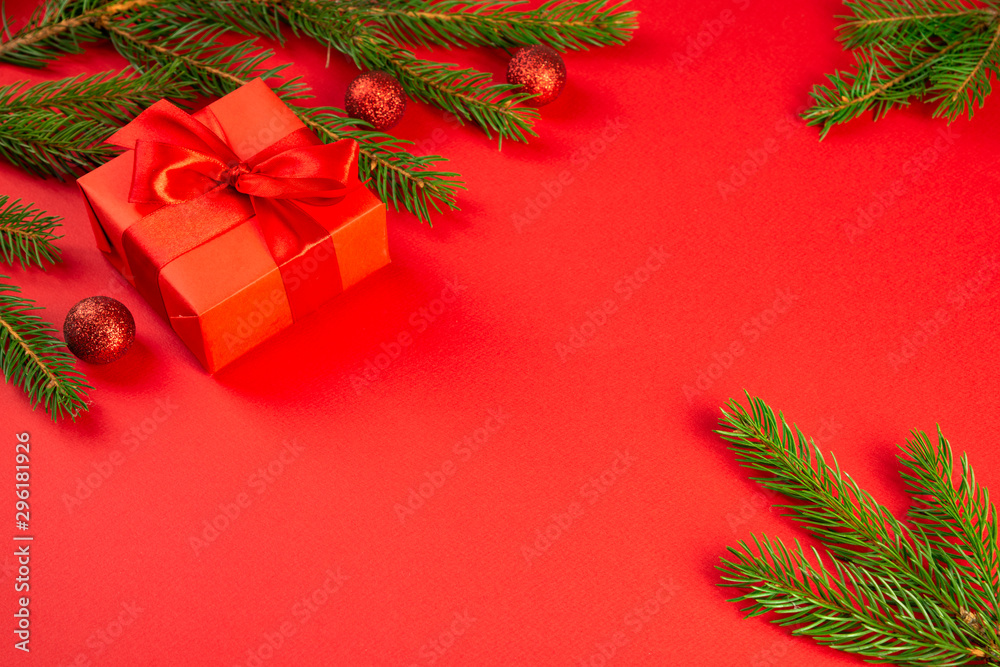 Christmas composition. Red gift, branches of spruce, red decorations on a red background. Christmas, winter, new year concept. Flat lay, top view, copy space Christmas composition. Red gift, branches of spruce, red decorations on a red background. Christmas, winter, new year concept. Flat lay, top view, copy space