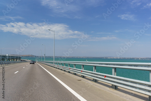 Crimean bridge across the Kerch Strait. Descent from the height of the navigable arch span. Ahead of Kerch and the sea is calm. Sunny day