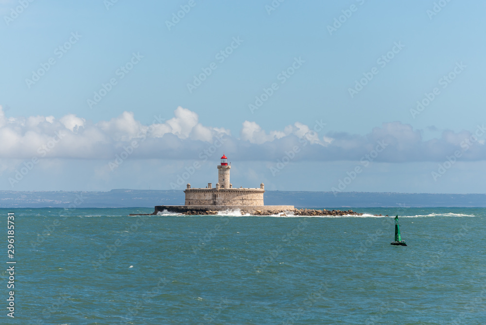 Lighthouse on small island at sea - The Fort of Sao Lourenco do Bugio